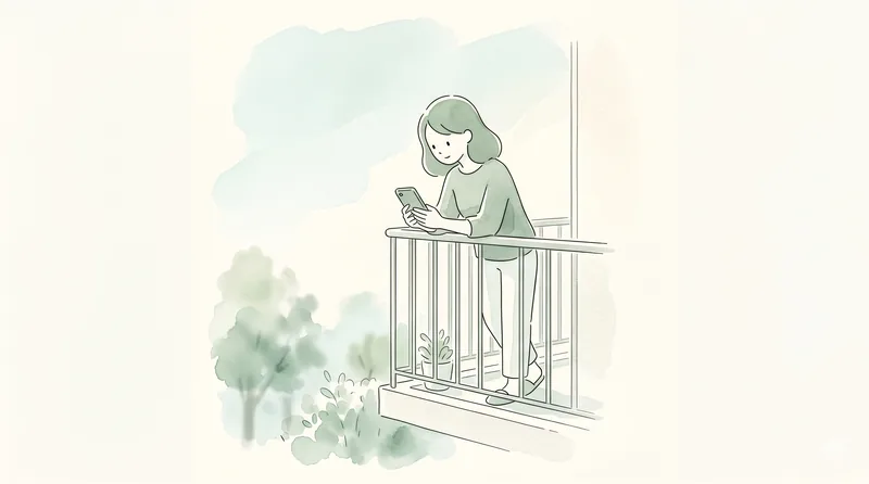 ベランダで屋外からスマホを確認している様子